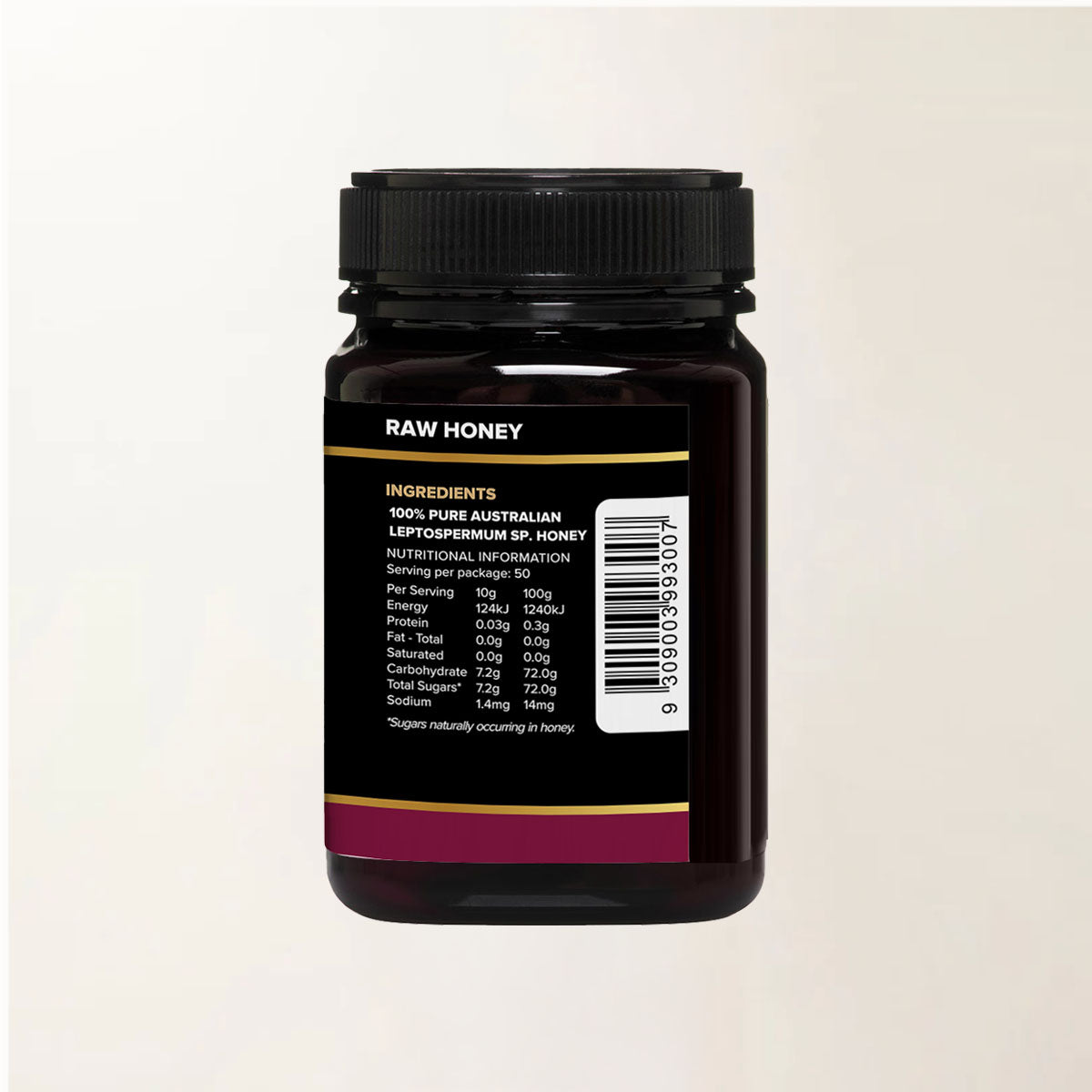 Black container of raw honey with a label on a beige background