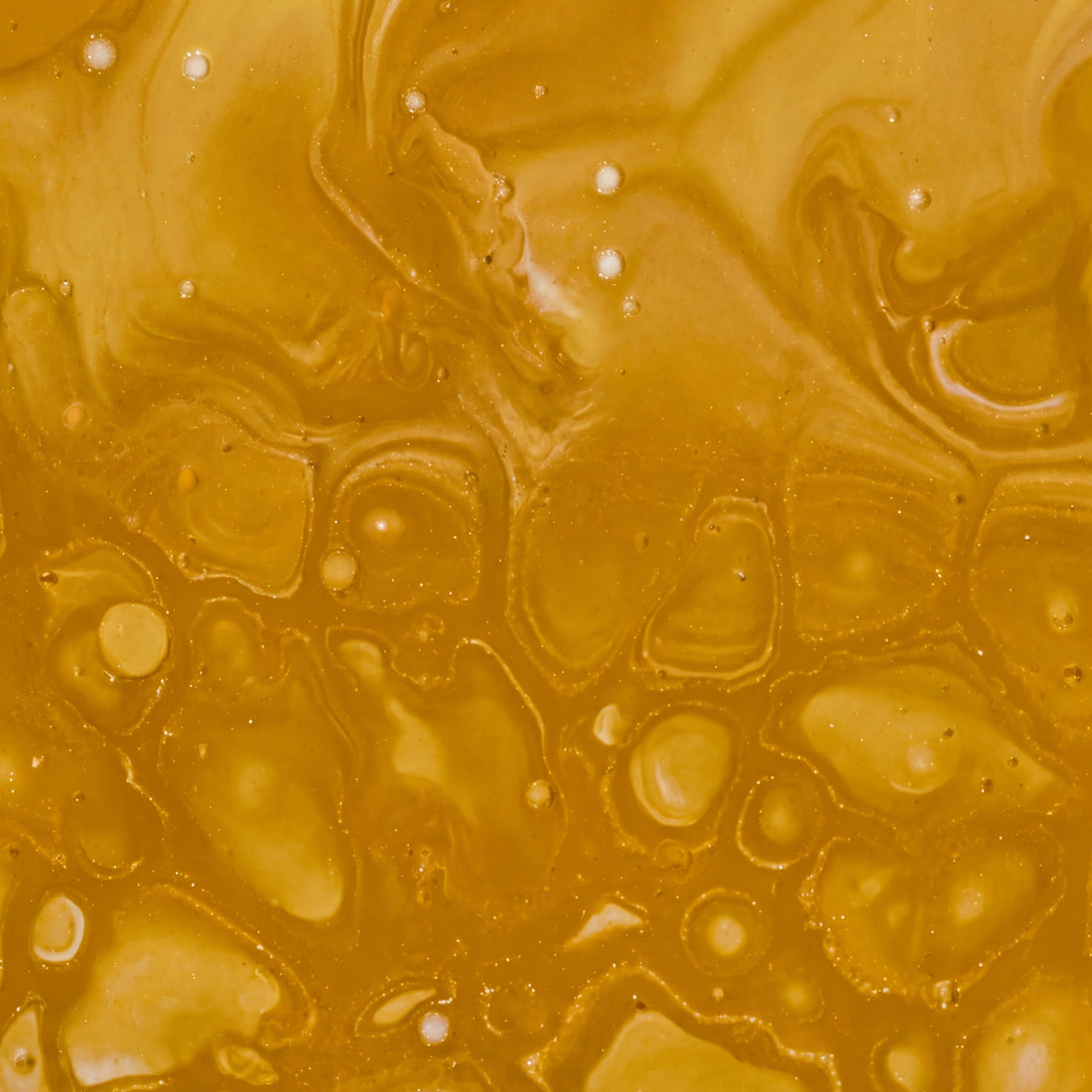 Close-up of a marbled brown and gold pattern of a honey