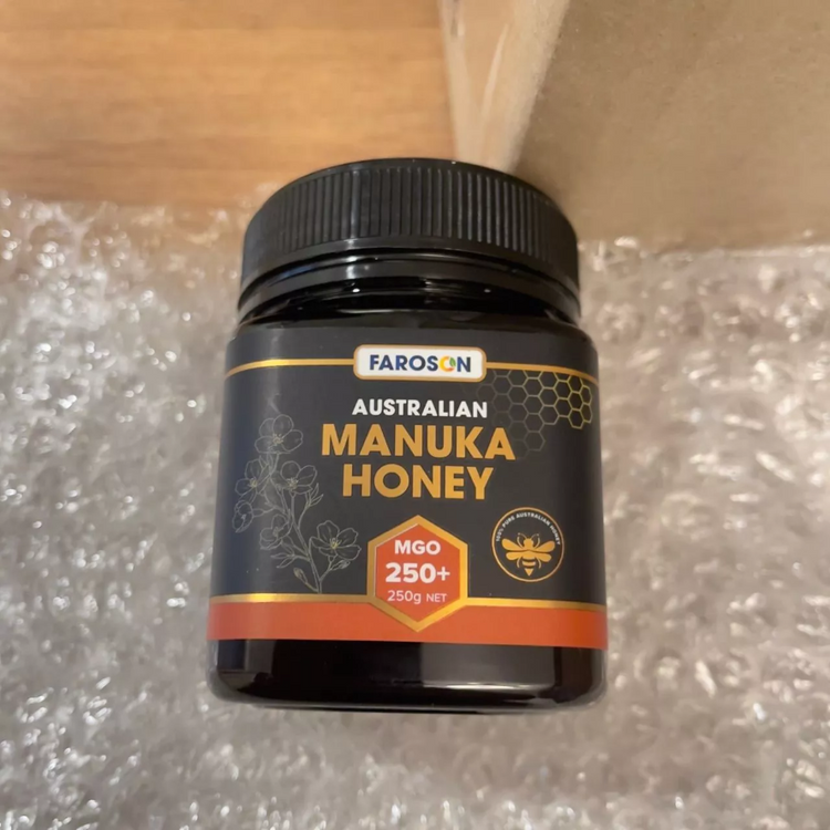 Jar of Farason Australian Manuka Honey on a textured surface
